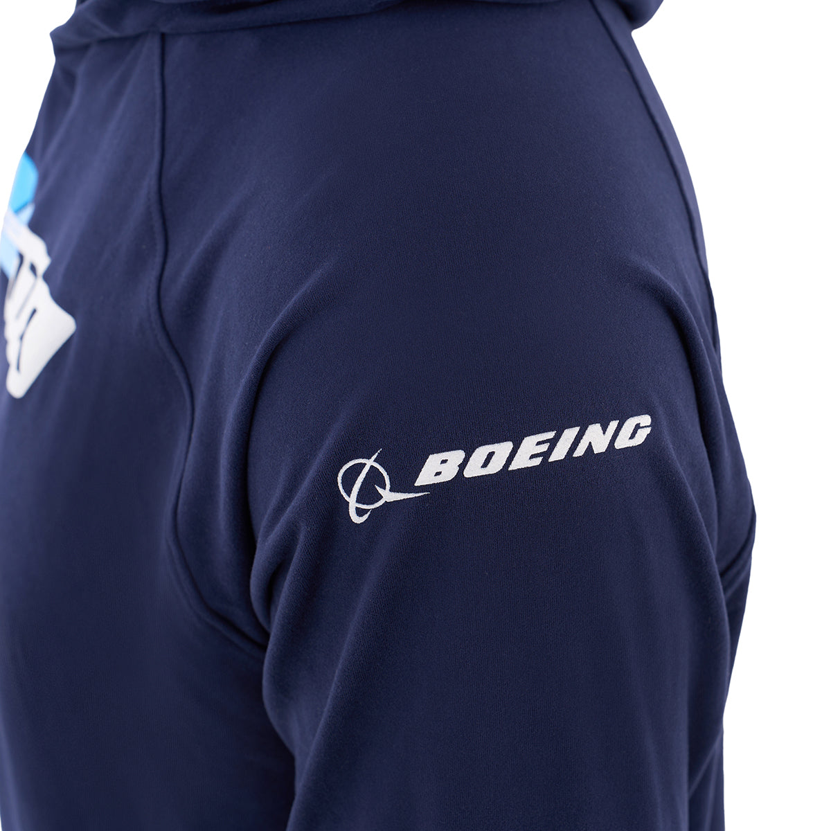 A close-up of a person’s arm wearing the BOEING 777X Velocity Unisex Tech Stretch Hoodie in navy blue, showing the white Boeing logo on the sleeve.