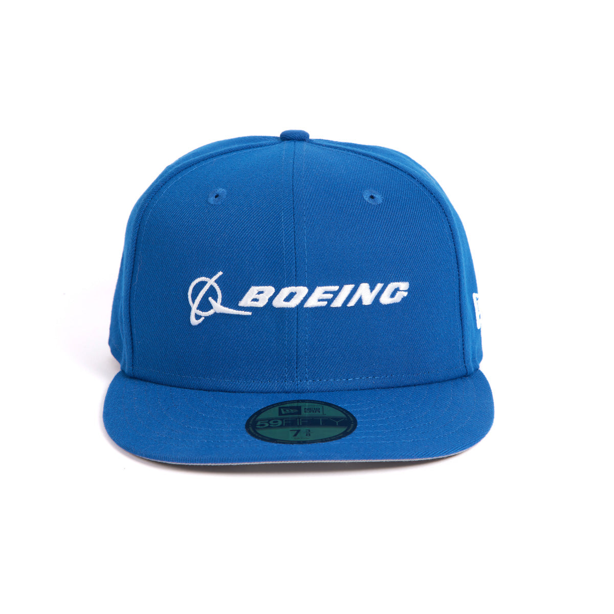 The Boeing Stores New Era 59FIFTY Hat is a blue fitted baseball cap with a beautifully embroidered white Boeing logo on the front. It includes a flat brim, top button, and a size-indicating sticker.