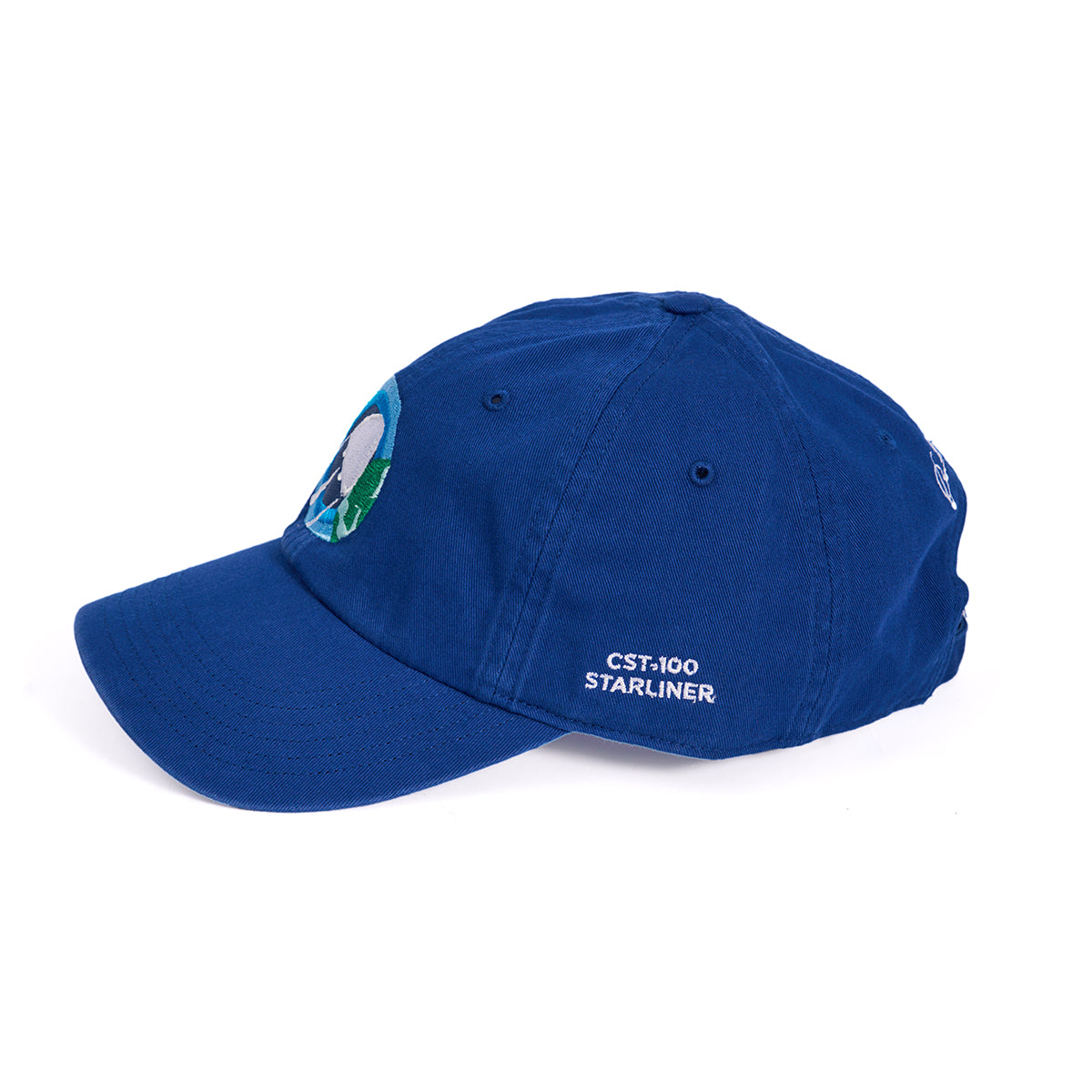 The Boeing CST-100 Starliner Skyward Hat is a blue cap with an embroidered front design, the text CST-100 Starliner on the side, a curved brim, and an adjustable cloth backstrap for a perfect fit.