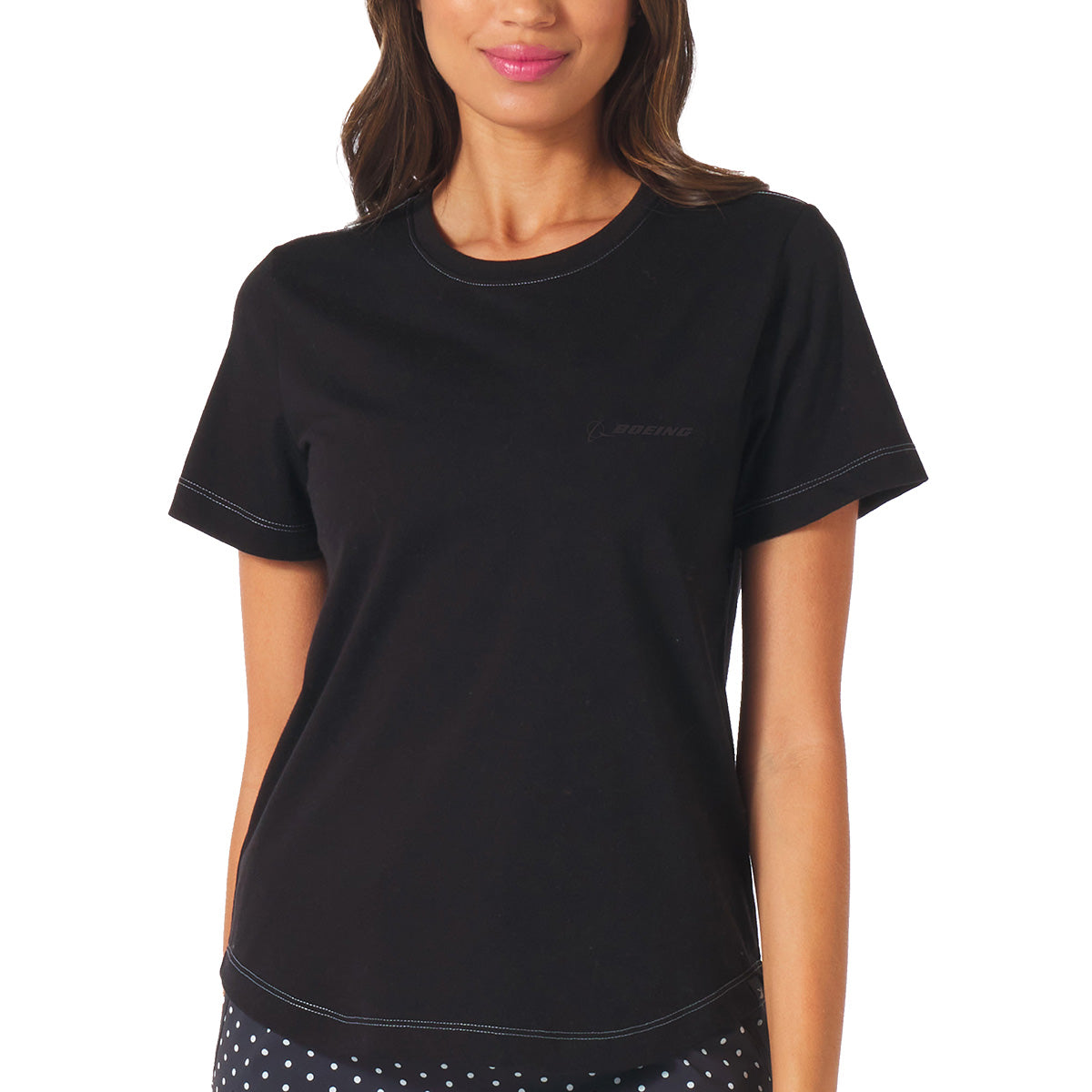 A woman wears the Glyder Boeing Women’s No Harm T-Shirt by BOEING—a black, short-sleeve organic cotton tee with subtle white stitching and a small Boeing logo on the chest—standing against a plain background, upper body and part of her face visible.