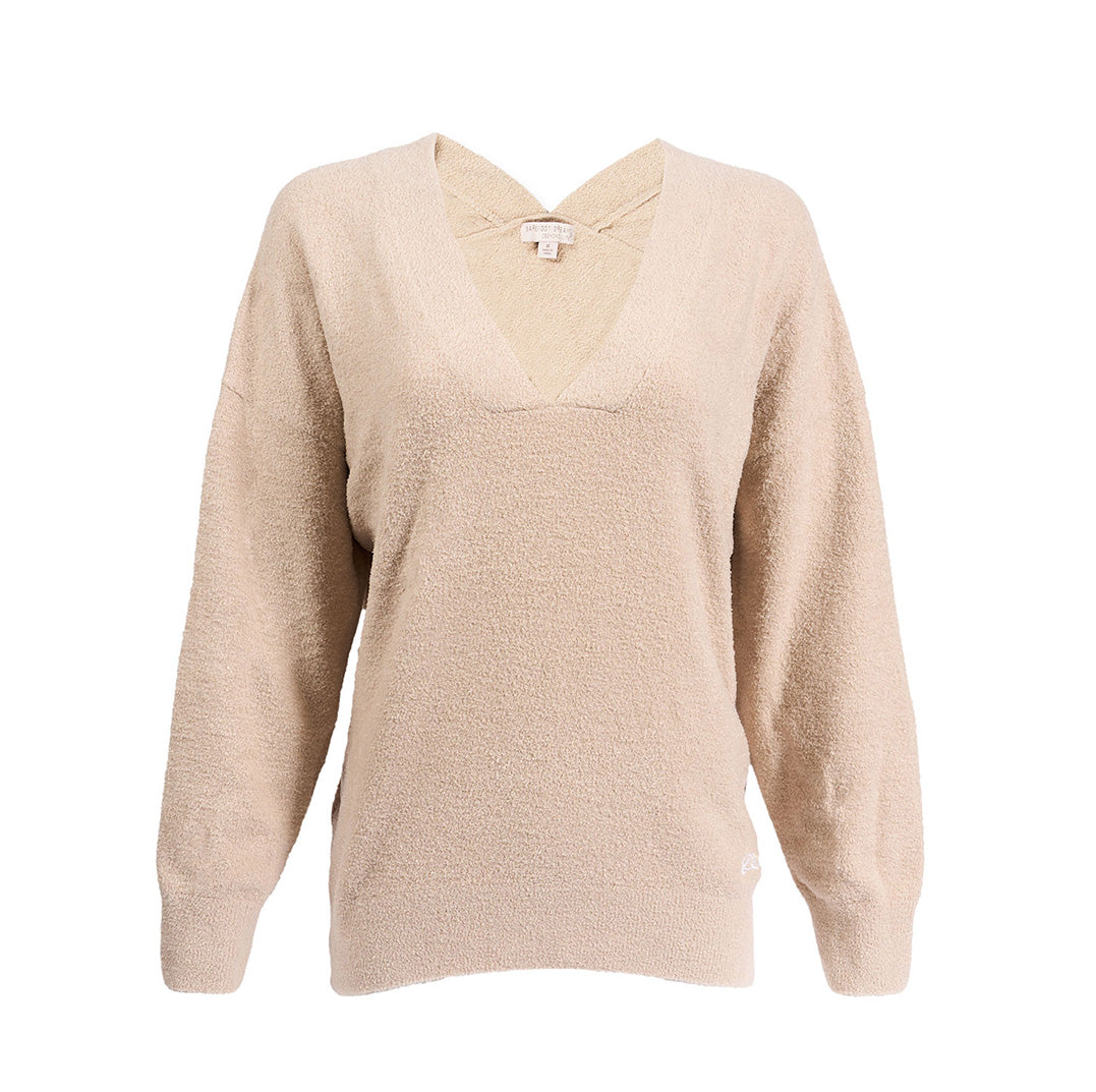 The Boeing Stores Barefoot Dreams Cozychic® V-Neck Pullover is a beige, long-sleeve, relaxed-fit sweater with textured fabric, a subtle cross-strap back detail, and a flattering hi-low hem.