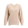 The Boeing Stores Barefoot Dreams Cozychic® V-Neck Pullover is a beige, long-sleeve, relaxed-fit sweater with textured fabric, a subtle cross-strap back detail, and a flattering hi-low hem.