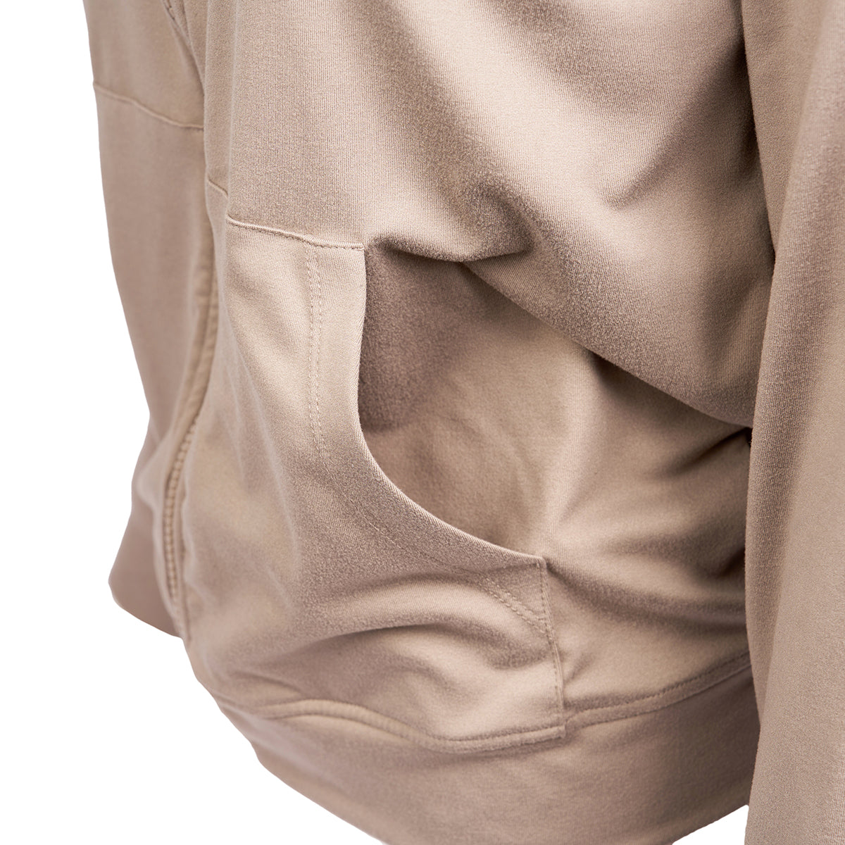 Close-up of the Barefoot Dreams Boeing Womens Butterchic Jacket by Boeing, featuring a beige zip-up design, mock neck collar, side pocket, and part of the front zipper—crafted from soft fabric with visible stitching details.