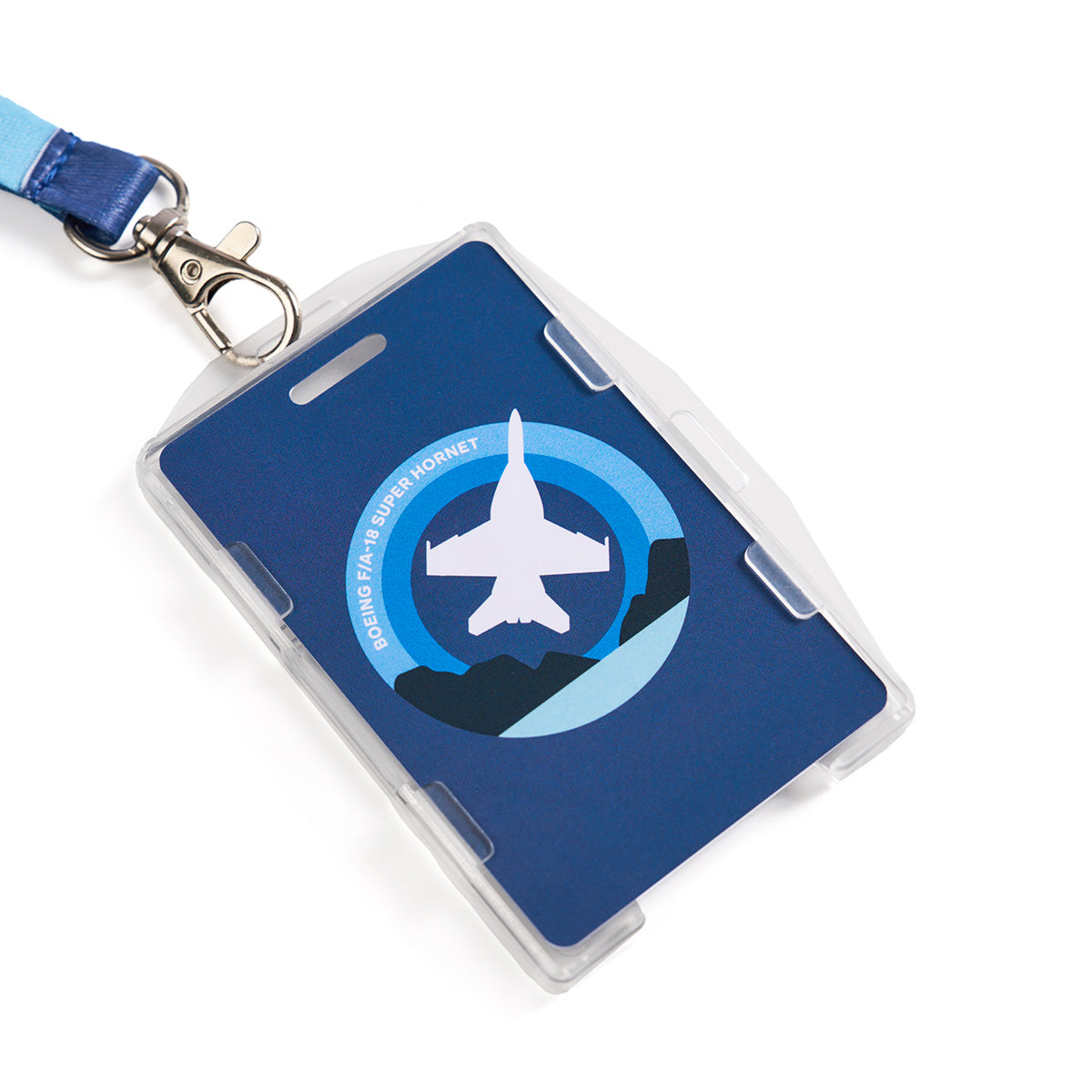 The Boeing F/A-18 Super Hornet Skyward Lanyard by Boeing features a sleek blue base with a sublimation print of a jet soaring over mountains. It includes Boeing F/A-18 Super Hornet text and a sturdy metal clip. The crisp white background complements the vibrant design.
