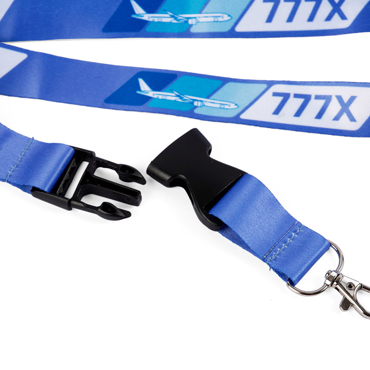 The Boeing 777X Velocity Lanyard by Boeing features a blue design with the sleek 777X graphics, black plastic buckle, silver metal clip, and a safety breakaway for extra security.