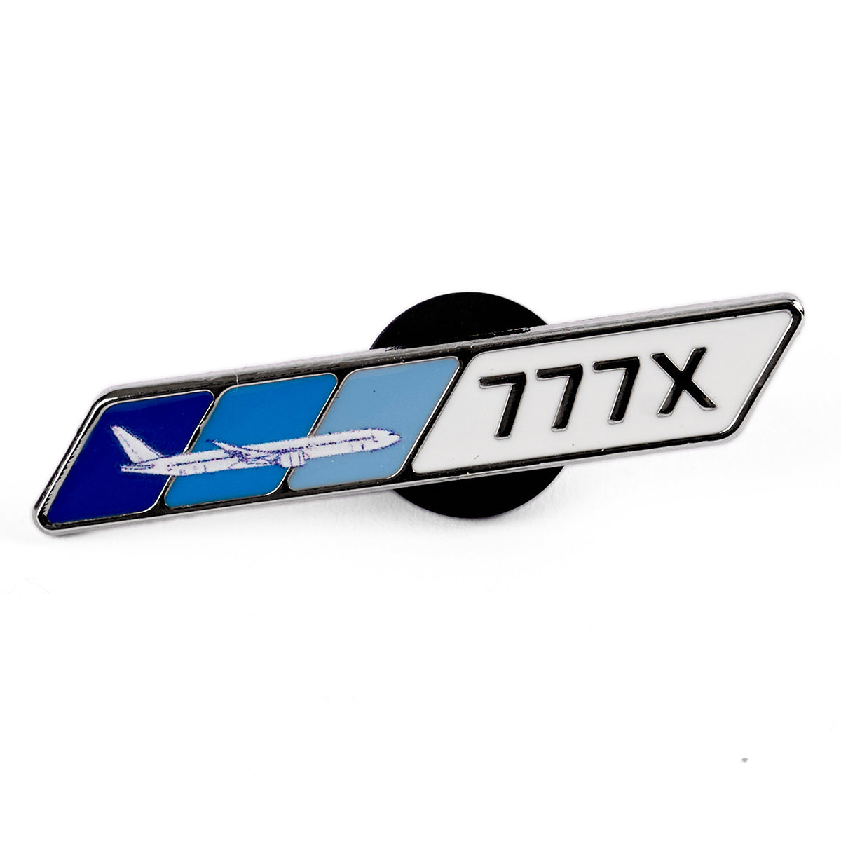 The Boeing 777X Velocity Lapel Pin from Boeing showcases a stylized airplane on a blue background, ideal for aviation enthusiasts. It features the text 777X prominently on a white background, celebrating the iconic aircraft.
