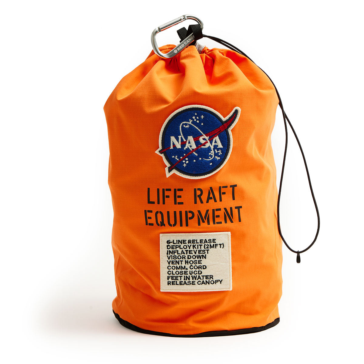 Orange bag with NASA logo and the text "Life Raft Equipment." Features list of items and instructions. Attached carabiner and black cord. Emergency preparedness theme.