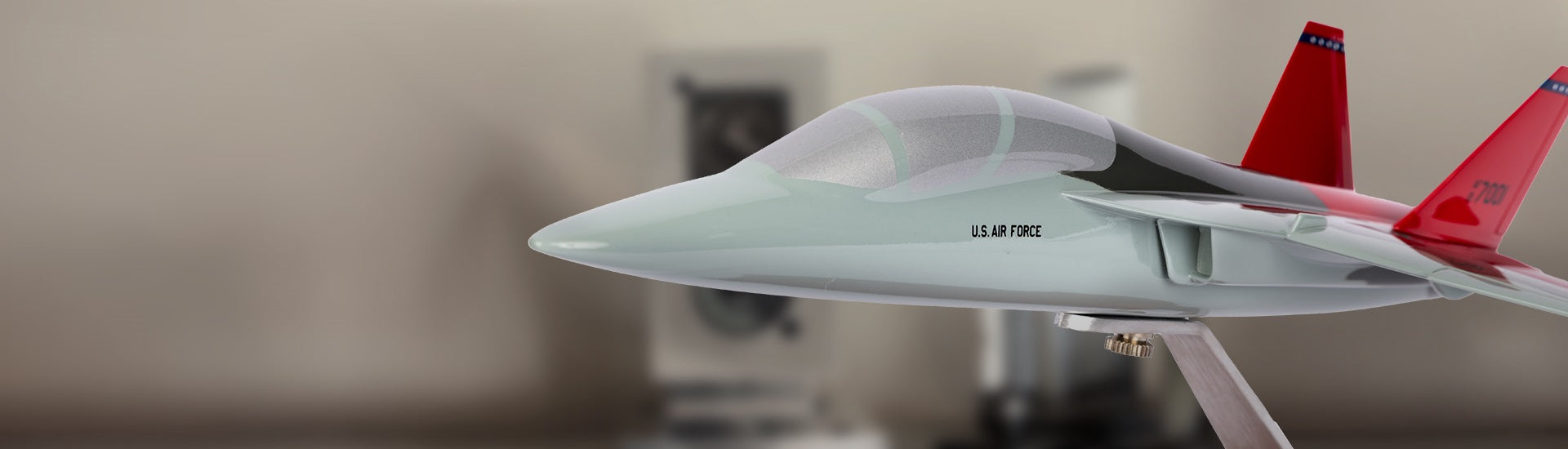 T7-A model airplane with red wings on a beige background