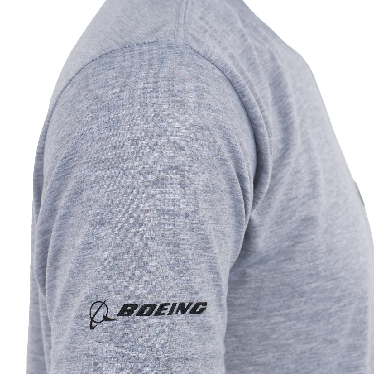 A close-up side view of a person wearing the BOEING CH-47 Chinook Series Unisex T-Shirt in light grey with a black Boeing logo on the sleeve—ideal for any aviation enthusiast.