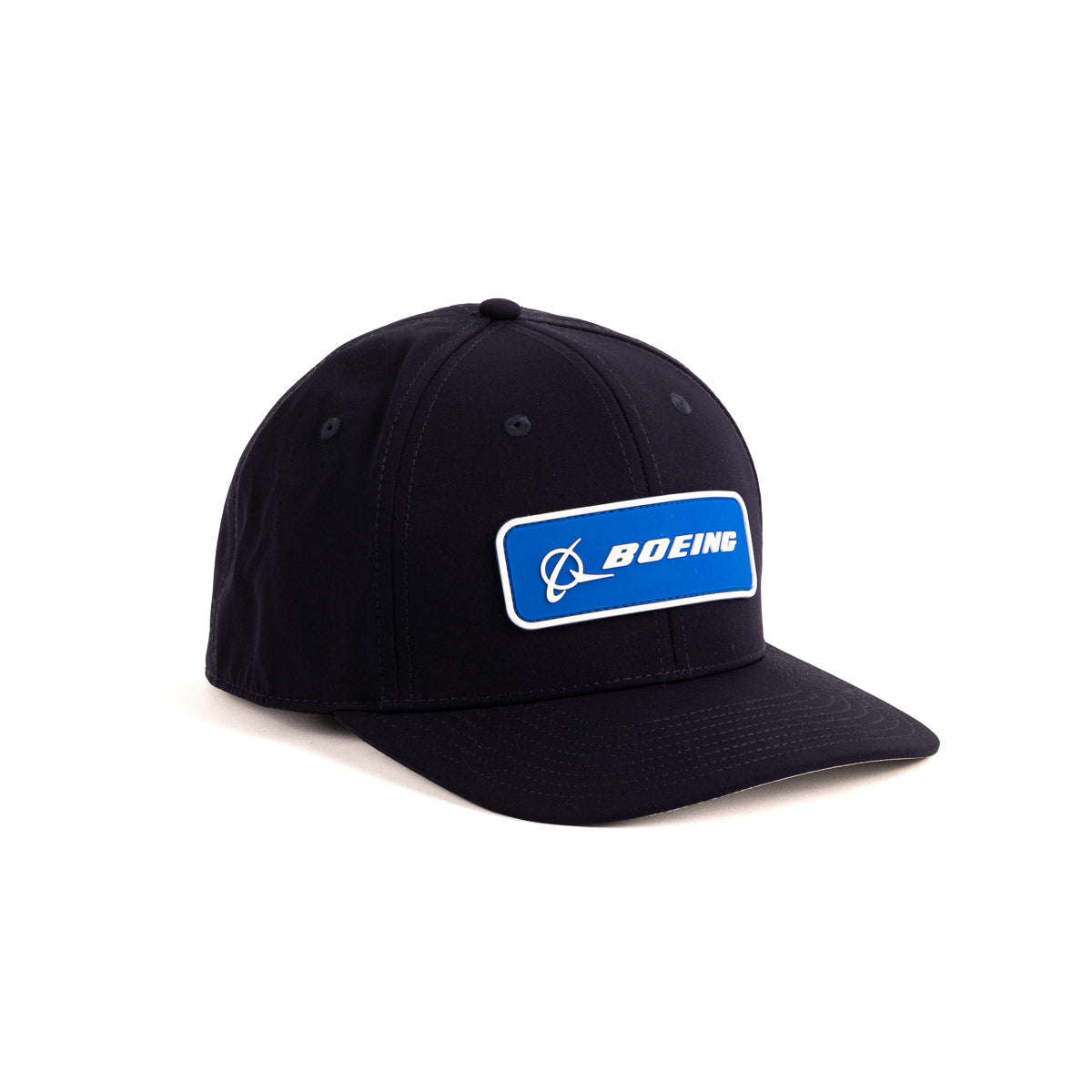 The Boeing Signature Logo Tech Snapback Hat by The Boeing Store is a black unisex cap with a curved brim, visible stitching, and adjustable snapback closure. It features a blue and white rectangular patch displaying the iconic Boeing logo in bold uppercase letters.
