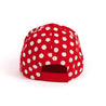 Rear panels with white polka dots.  Solid red velcro adjustable back strap. 