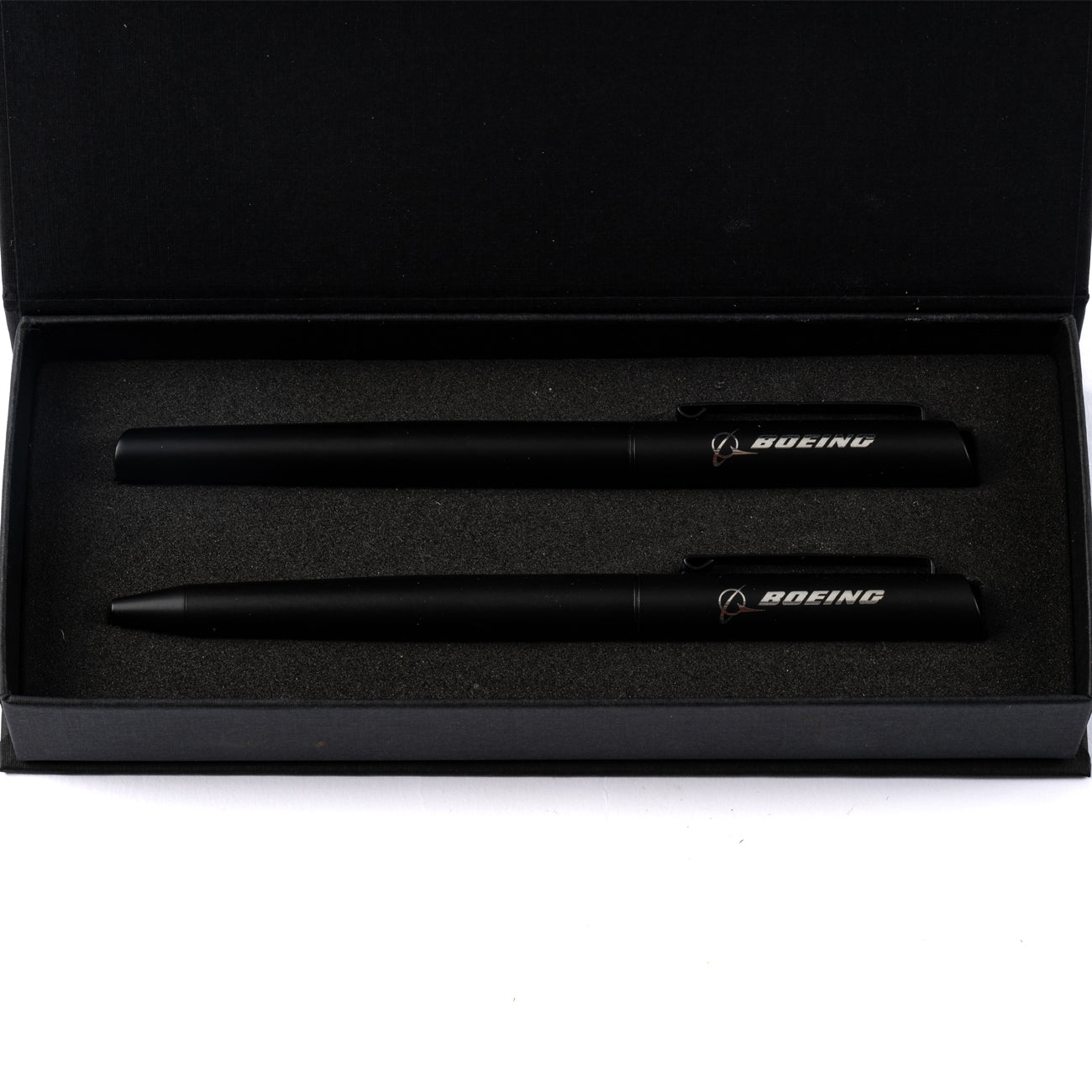 The Boeing Store’s Boeing Angle Tip Pen Set includes a pen and pencil with white and silver Boeing logos, packed in a black foam-padded box. The stylish pen writes smoothly in black ink.