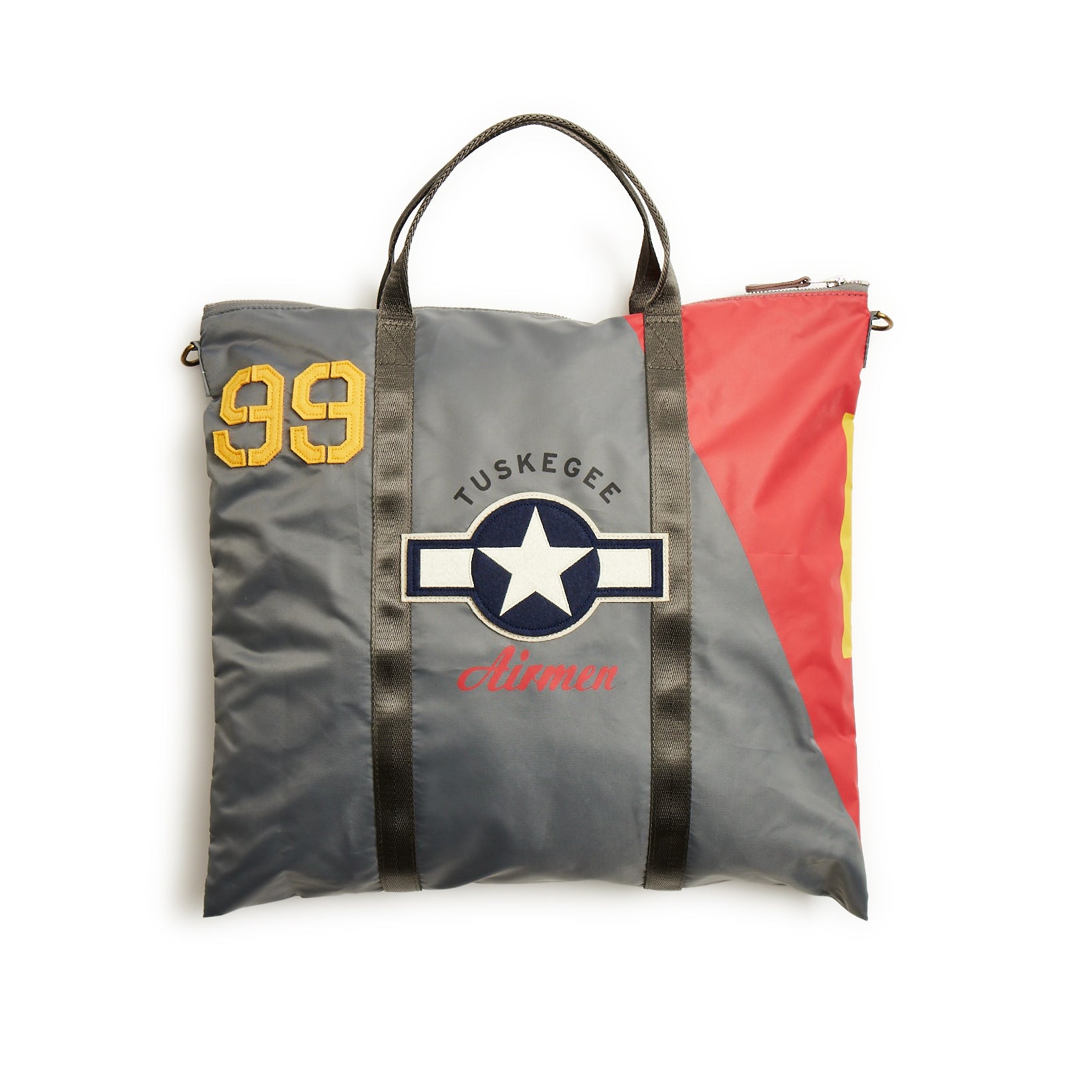 The Boeing Stores Red Canoe Tuskegee Helmet Bag showcases TUSKEGEE airmen around a star, with gray tones, red and yellow accents, and the number 99. It features durable YKK zippers and two top black straps for ease of carrying.