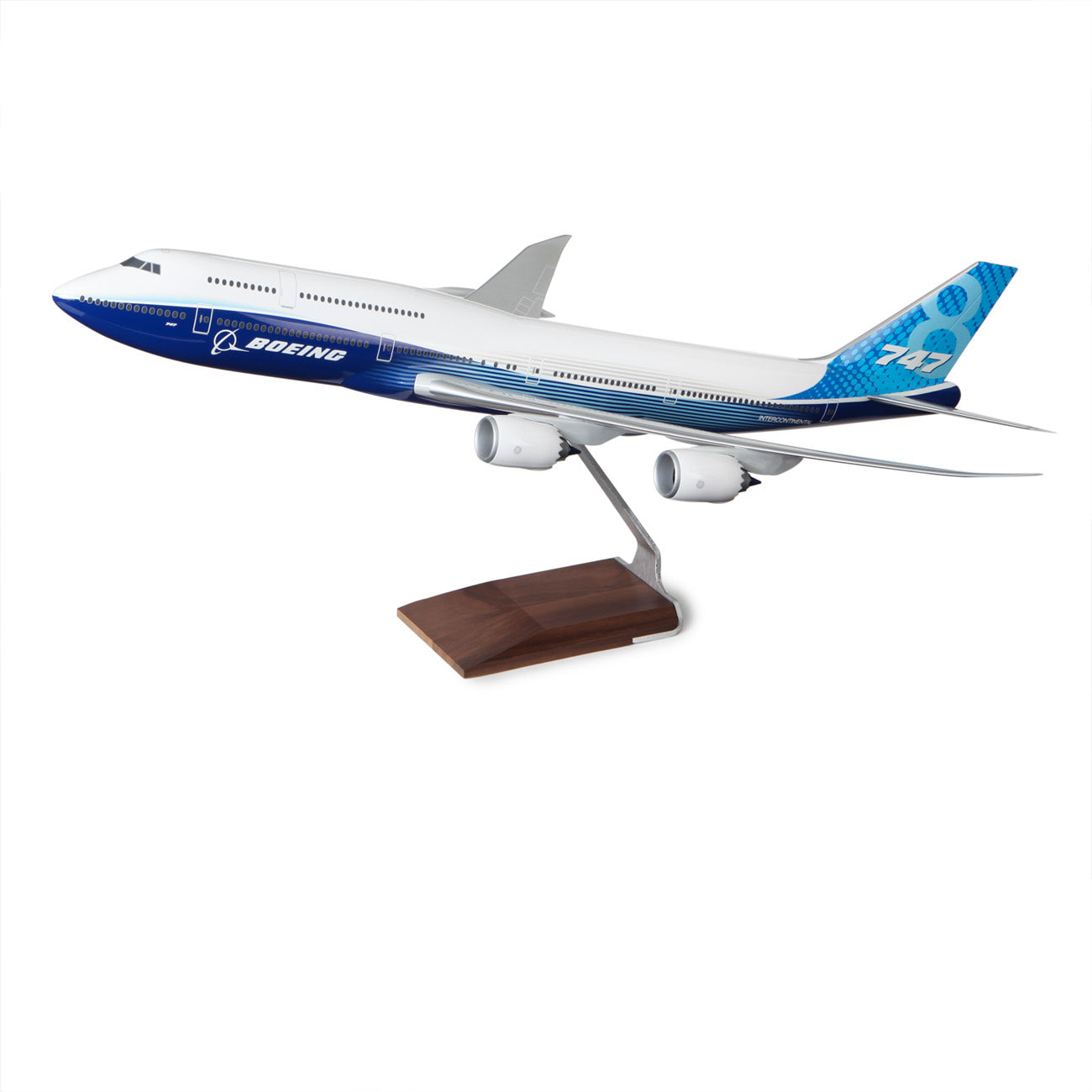 The Boeing Store’s Boeing 747-8 Intercontinental Resin 1:100 Model features blue and white livery, is mounted on a metal stand with a wooden base, and is photographed isolated on a white background.