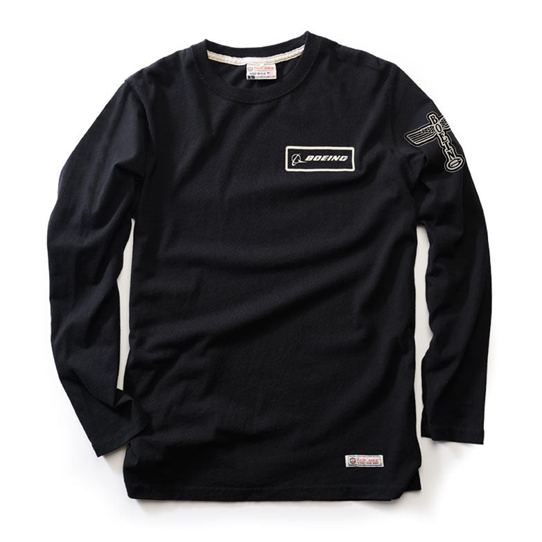 The Red Canoe Boeing Long Sleeve T-Shirt by The Boeing Store is a black shirt featuring the Boeing logo on the chest and an aviation-themed emblem on the sleeve, highlighted with visible stitching for a subtle yet stylish look.