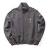 The Boeing Stores Red Canoe full zip sweatshirt is gray with a high collar, displaying the Boeing Airplane Logo and Boston on the left chest, an American flag patch on the right sleeve, a front zippered pocket, made of cotton poly fleece, and set against a plain white background.