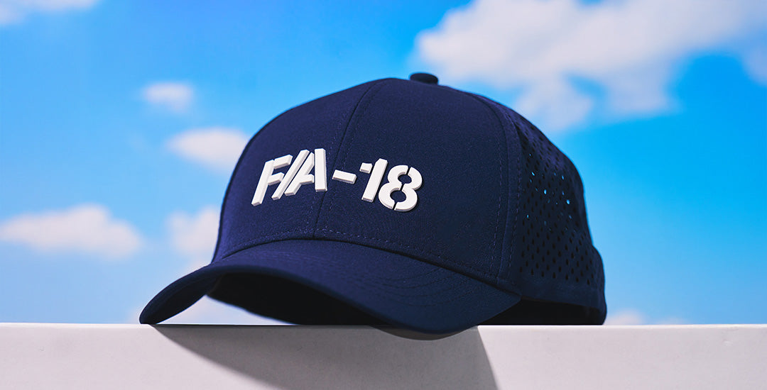 Boeing SLS Series Hat with the SLS logo on the left front, against a blue sky with clouds.