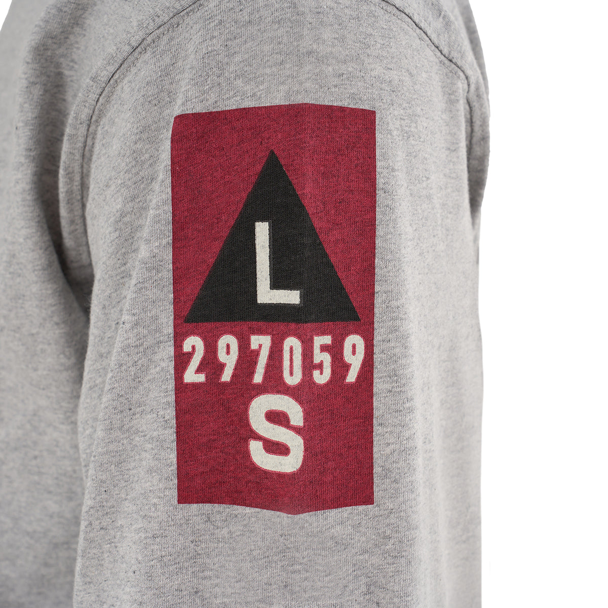 A close-up of The Boeing Store’s Red Canoe Boeing Airplane Company Logo B-17 gray 100% cotton long-sleeve t-shirt sleeve, showing a red patch with a black triangle, white L and S, and the number 297059 in white.