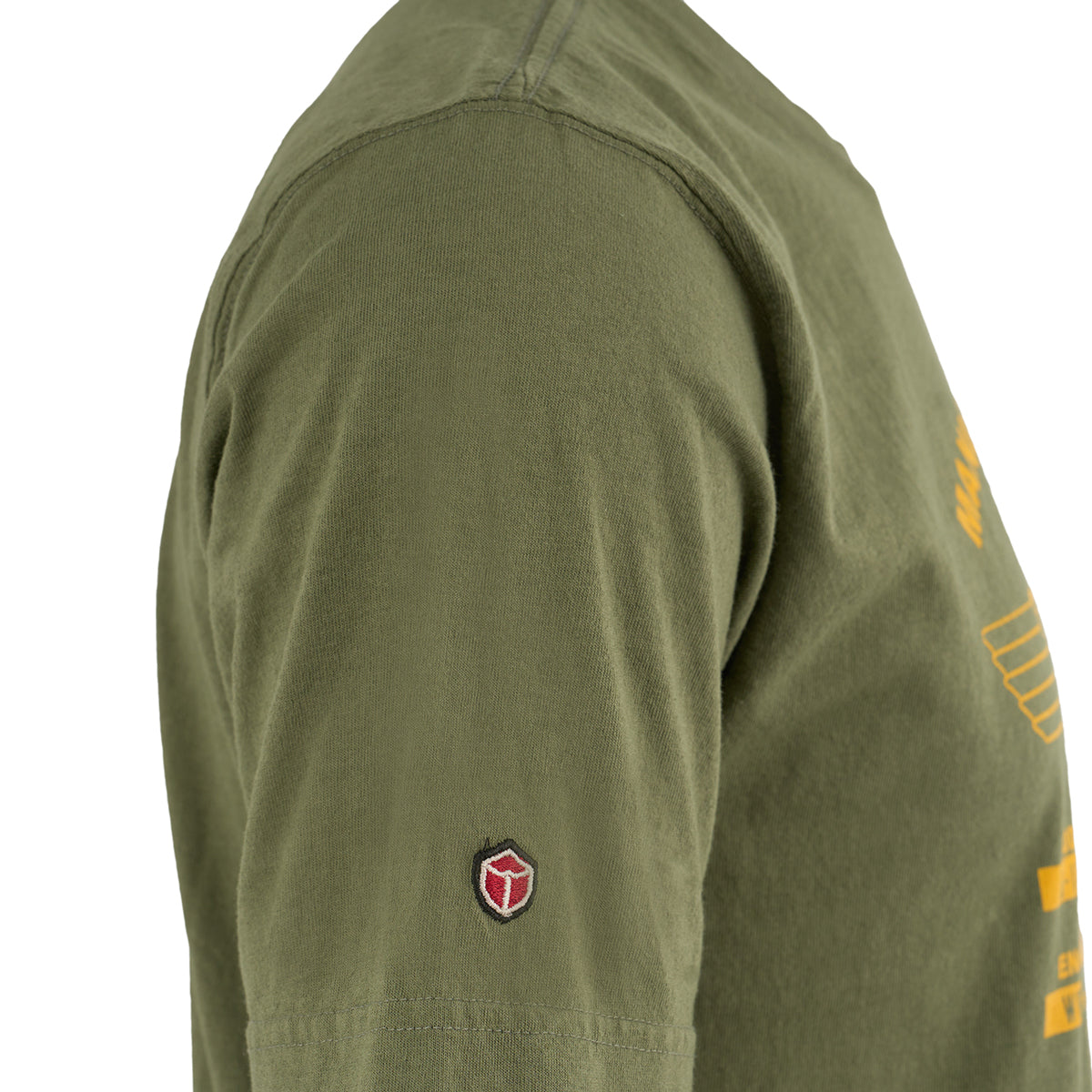 Close-up side view of a person wearing The Boeing Stores Red Canoe Boeing Airplane Company Logo T-Shirt in olive green, made from 100% cotton, featuring a red and black shield patch on the sleeve and yellow retro Boeing logo text on the chest.