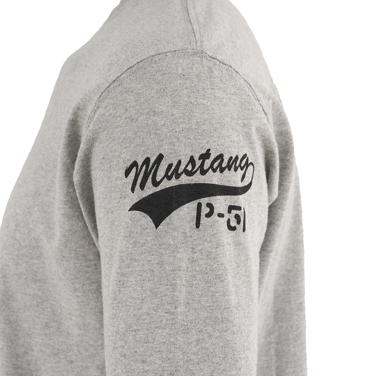 A close-up of The Boeing Store’s Red Canoe Tuskegee Airmen Long Sleeve T-Shirt in light gray, showing Mustang above P-51 on the upper arm—honoring the legendary P-51 Red Tail Mustang pilots.