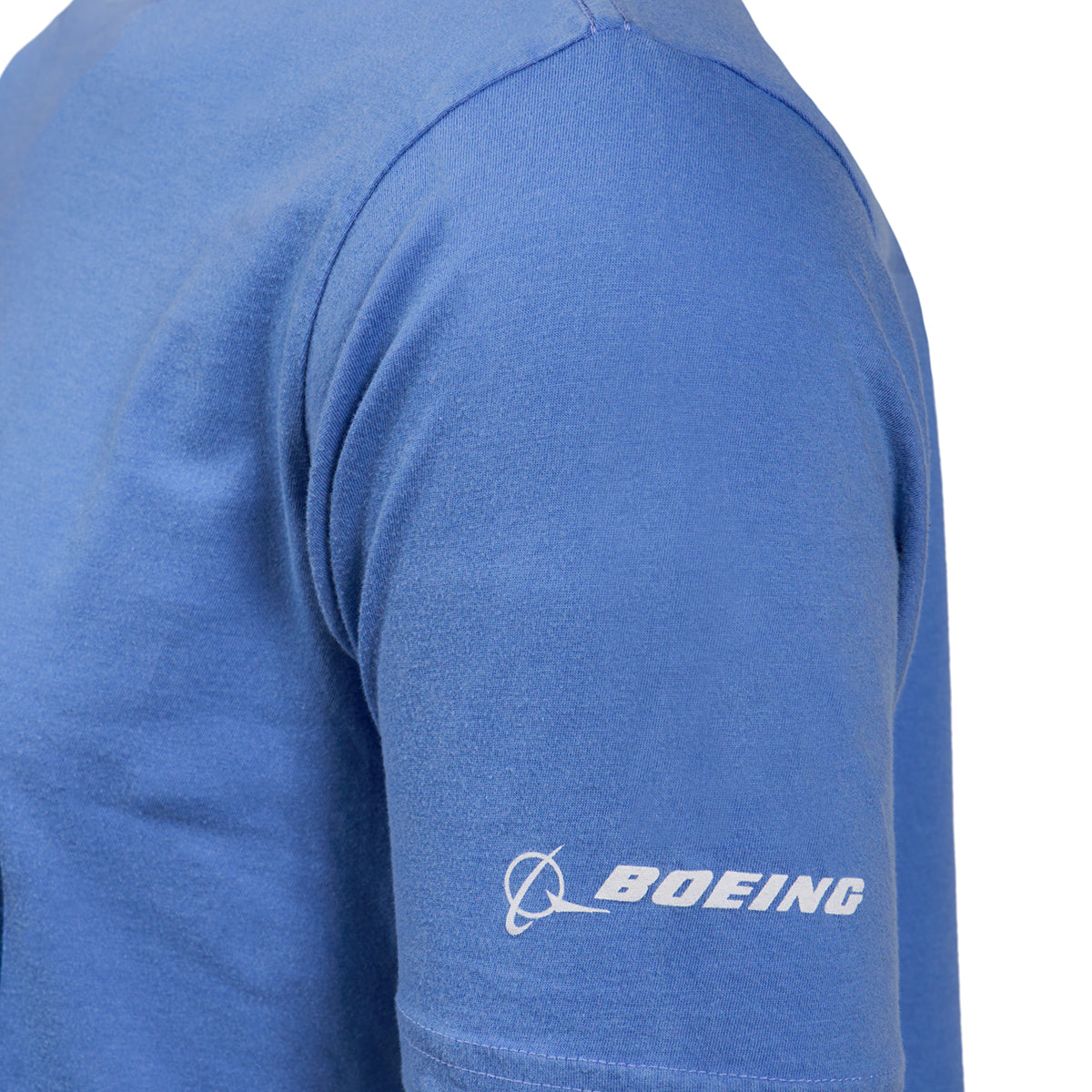 Close-up of the sleeve from a Boeing Horizon Mens T-Shirt in blue, showcasing the iconic Boeing logo in white on the left side. Ideal for aviation enthusiasts, this tee embodies innovation. The crisp white background accentuates every detail.