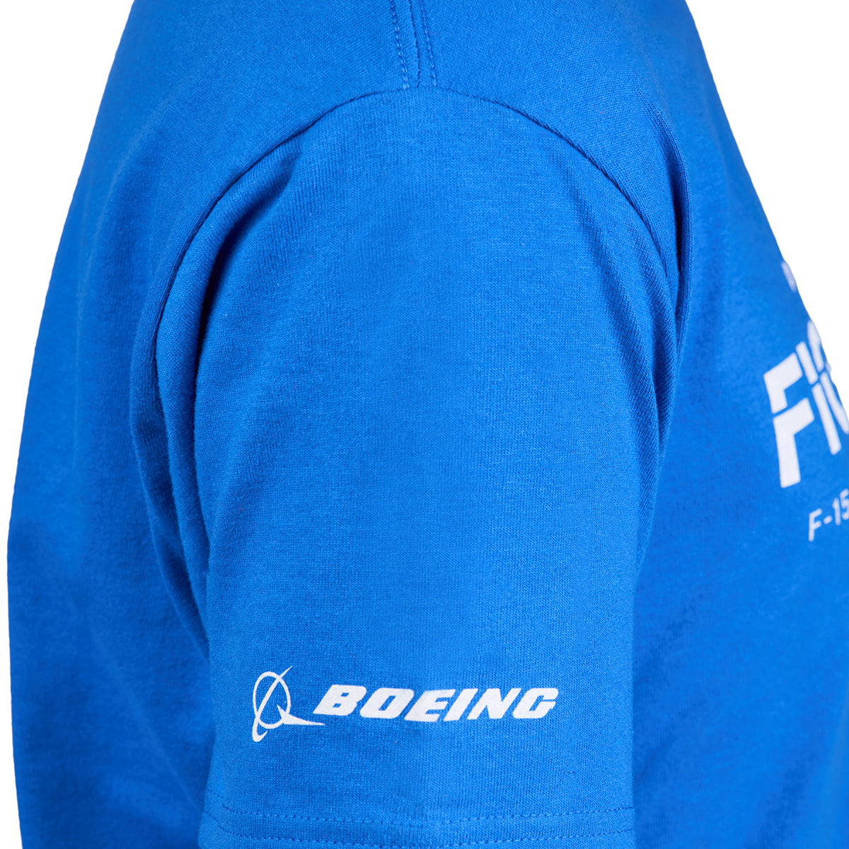 Close-up of someone wearing a Boeing Fighters F/A-18 Unisex T-Shirt in bright blue. The Ultra Cotton fabric feels soft, and the sleeve prominently displays a white Boeing logo.