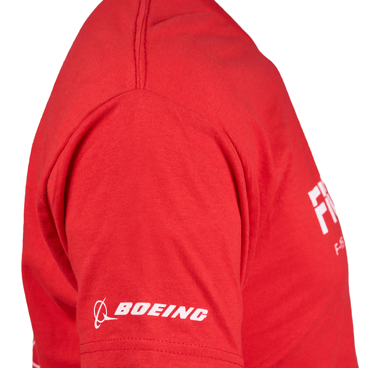 Side view of a person in a Boeing Fighters Unisex T-Shirt by Boeing, featuring an Ultra Cotton red fabric, with a small white Boeing logo on the sleeve and part of the front design celebrating Air Dominance Fighters.
