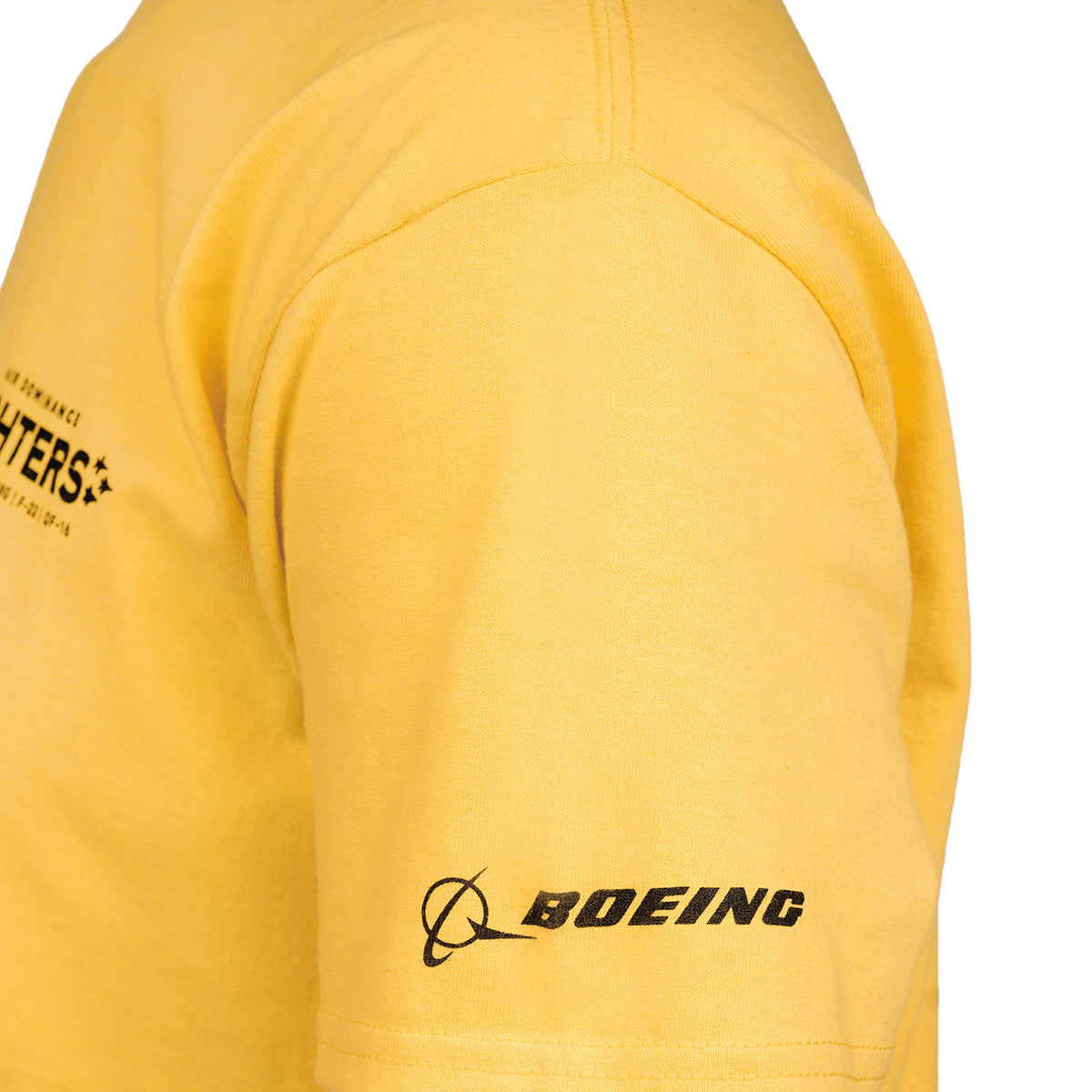 Close-up of someone in a yellow Boeing EA-18G Growler Unisex T-Shirt, featuring the iconic Boeing logo on the sleeve with its circle and swoosh design, along with Boeing in bold black letters. The shirt also hints at EA-18G Growler text, partially visible.