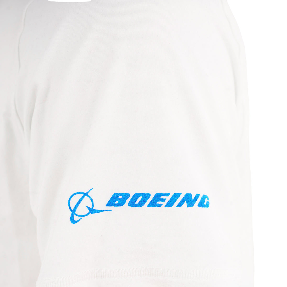 Close-up of the Boeing 787 Dreamliner Velocity Unisex Tech Stretch T-Shirt sleeve in white, showing the blue BOEING logo and text on the lower part, inspired by the iconic aircraft.