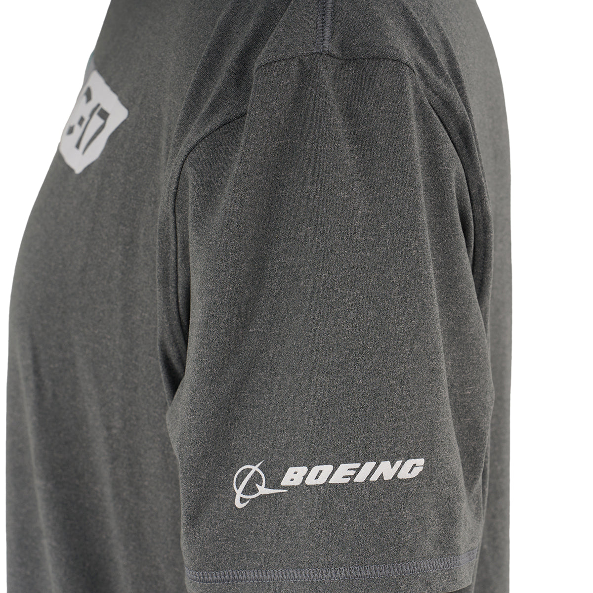 A close-up of the BOEING C-17 Globemaster Velocity Unisex Tech Stretch T-Shirt in gray, showcasing an athletic fit, white BOEING logo on the left sleeve, and a partial chest logo or number.
