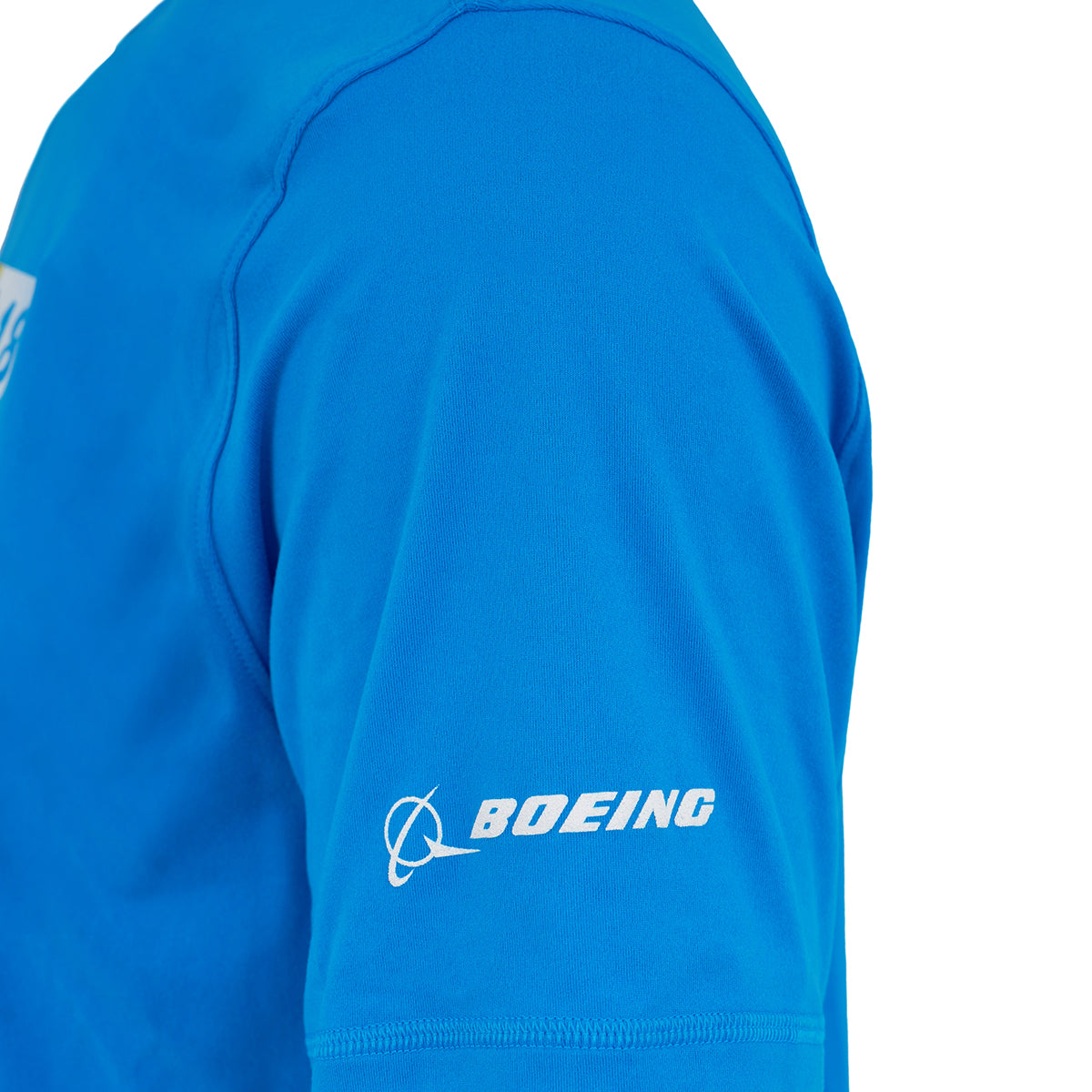 Close-up of a person wearing the BOEING F/A-18 Super Hornet Velocity Unisex Tech Stretch T-Shirt in bright blue, featuring the BOEING logo and name printed in white on the sleeve.