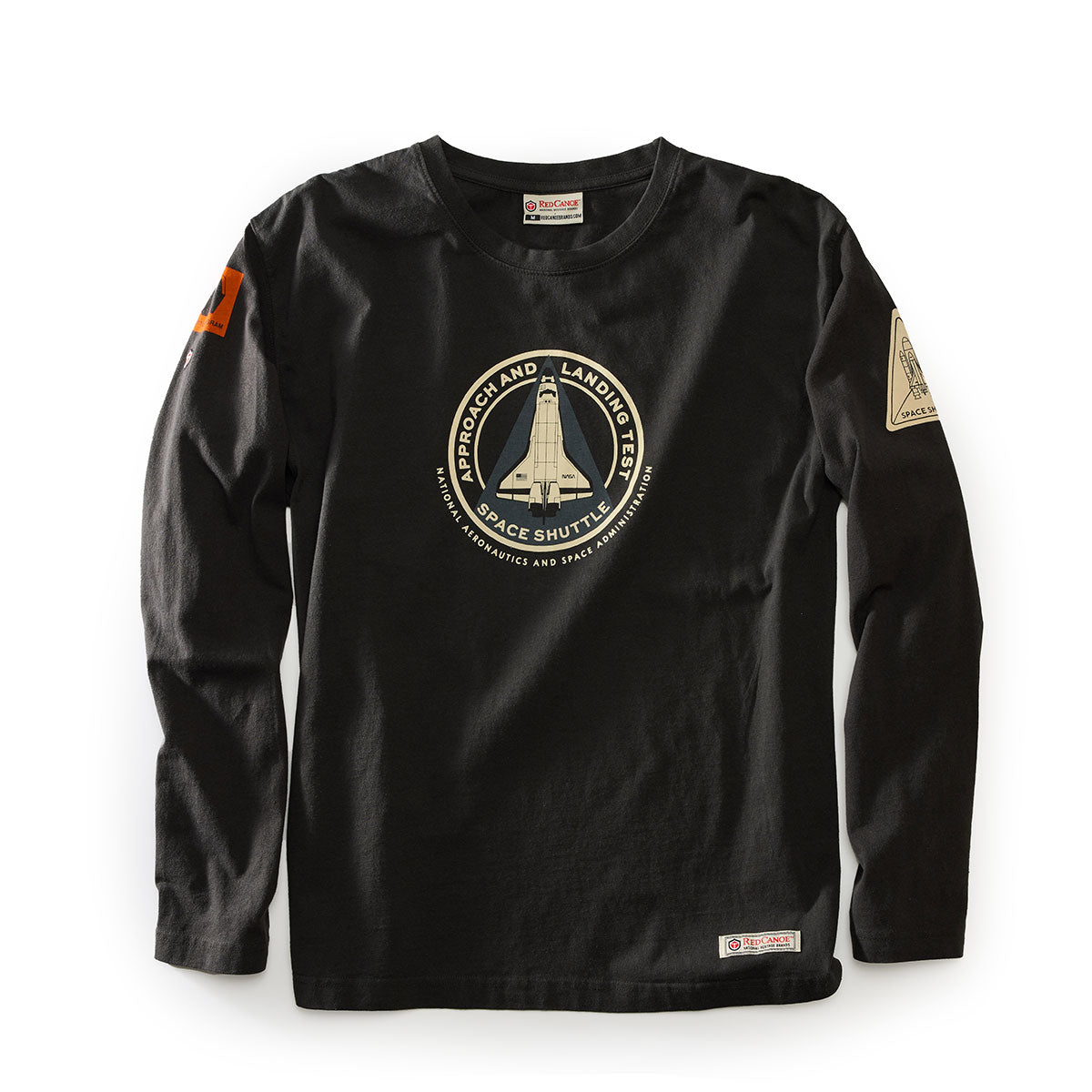 The BOEING Red Canoe Space Shuttle Mens Long Sleeve T-Shirt is black with a chest patch showing the Space Shuttle and Approach and Landing Test Space Shuttle, plus extra patches on the right sleeve and left shoulder.