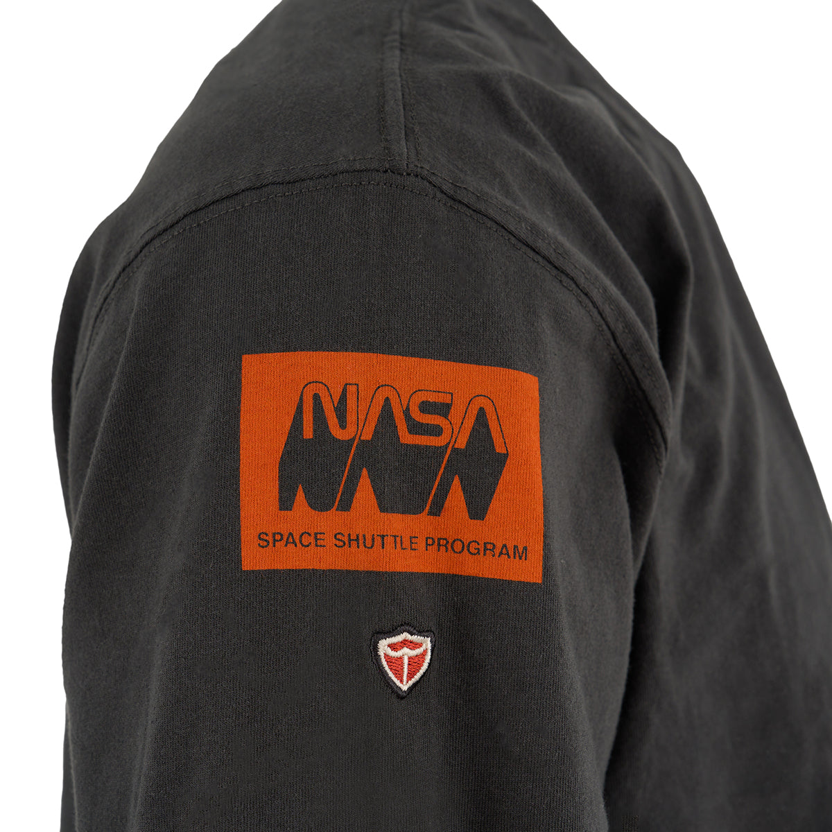 The Red Canoe Space Shuttle Mens Long Sleeve T-Shirt by BOEING features an orange Space Shuttle Program logo and a red and white embroidered patch below, ideal for NASA apparel fans.