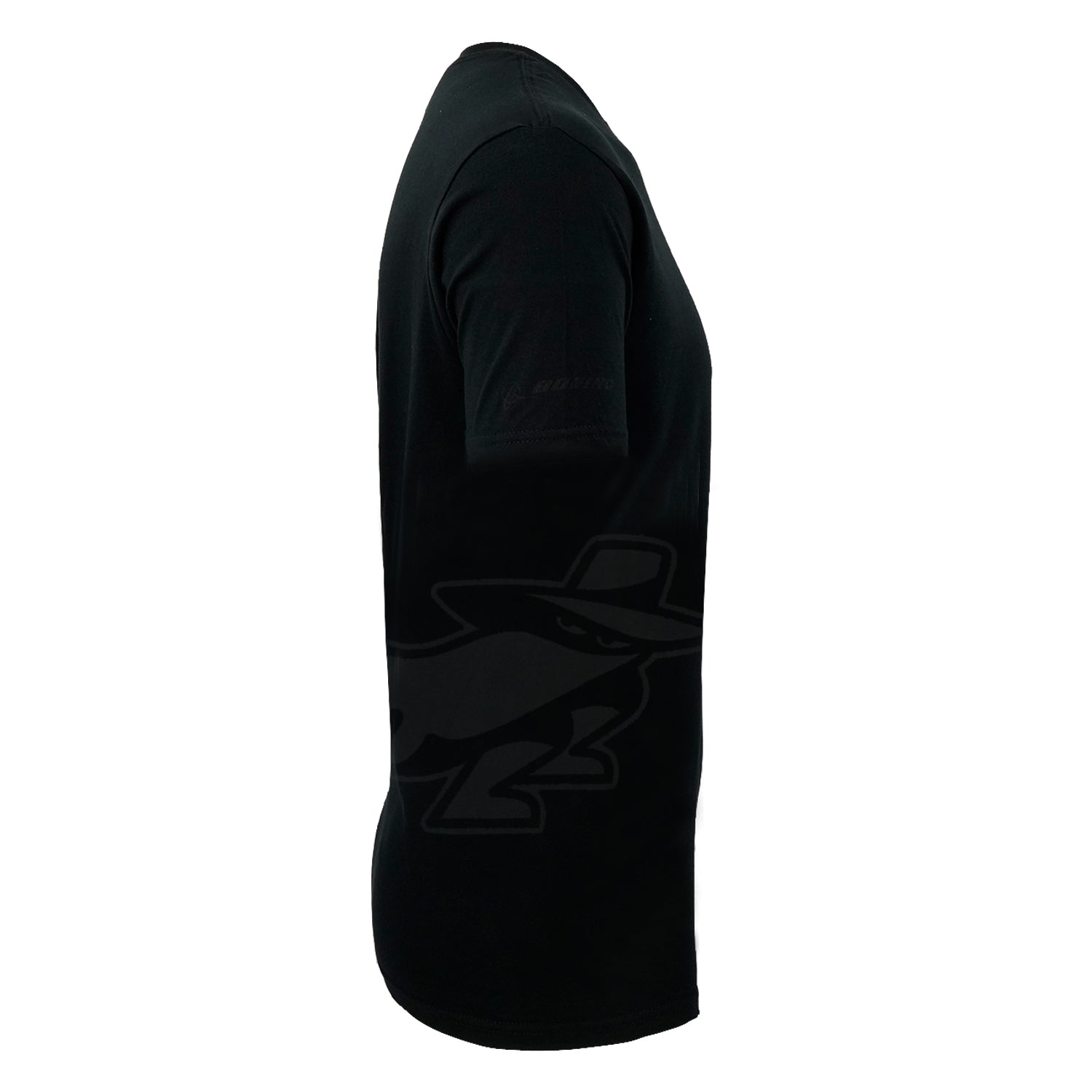 The BOEING Phantom Works 2025 Men’s T-Shirt is shown from the side in black, with a subtle stylized character in a hat graphic on the lower side, reflecting innovation in aerospace technology.