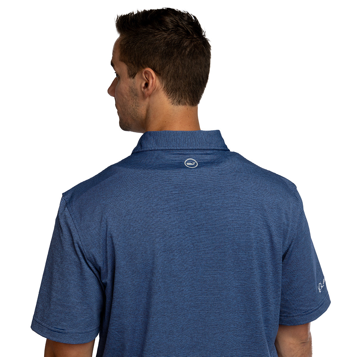 A man with short brown hair is seen from the back wearing the Vineyard Vines Boeing Men’s Micro Stripe Polo by Boeing, featuring subtle horizontal stripes, a small circular logo below the collar, and moisture-wicking fabric.