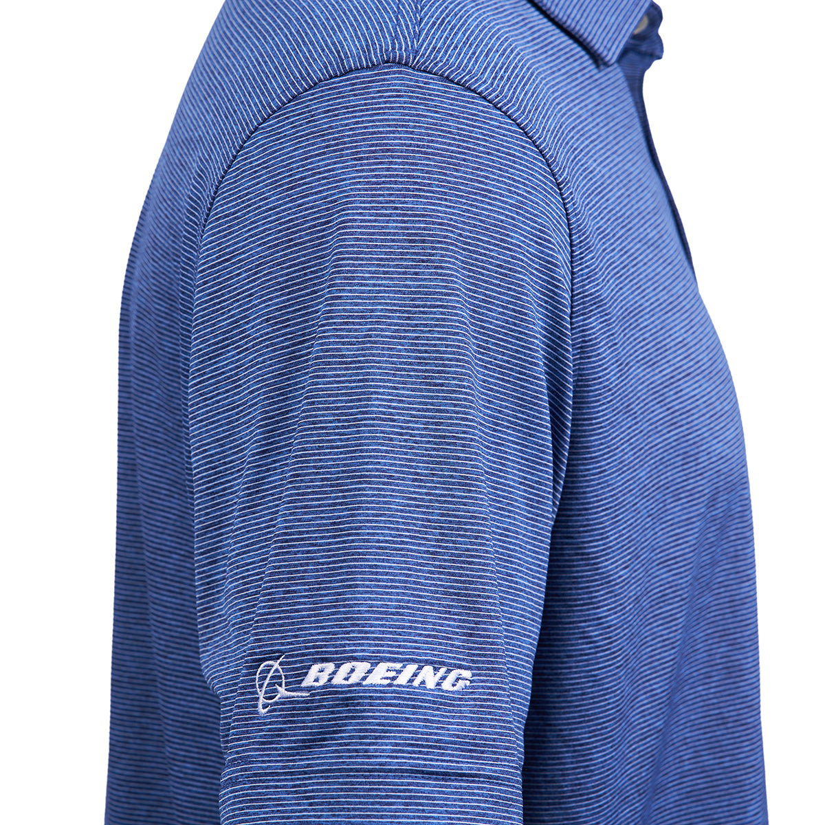 Close-up of a person in the Vineyard Vines Boeing Men’s Micro Stripe Polo, a blue classic shirt with thin stripes and a white Boeing logo on the sleeve. Offers UPF 50 sun protection. Person’s face is not shown.