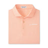The Peter Millar Boeing Men’s Santos Geo Performance Polo is a peach polo with a subtle geo pattern, UPF 50+ protection, and features the white Boeing logo on the chest and a Peter Millar collar tag.