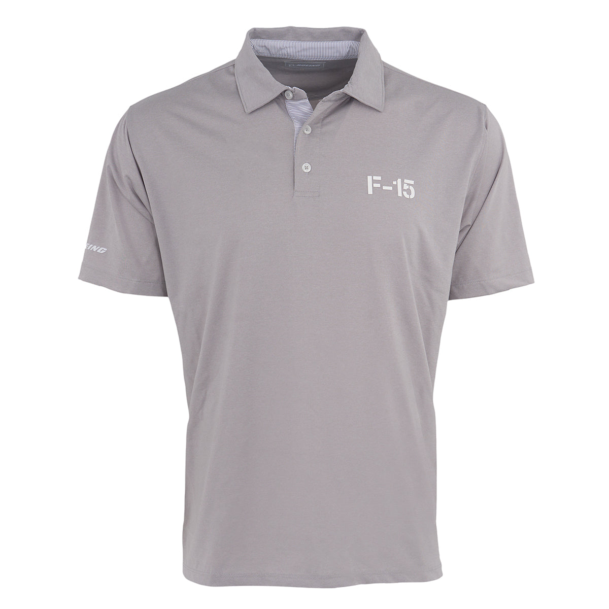 The Boeing F-15 Eagle Series Men’s Polo by BOEING is a light gray, short-sleeve polo with a collar and three buttons, featuring F-15 in white on the chest and Boeing on the sleeve. Moisture-wicking for all-day comfort.