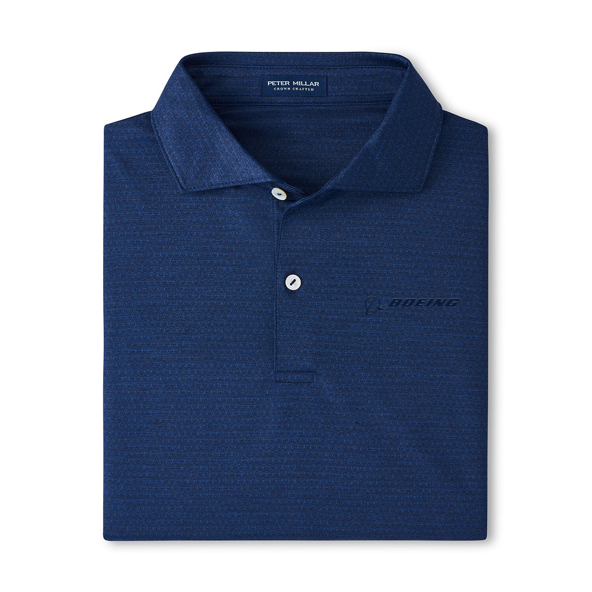 The Peter Millar Boeing Men’s Jukebox Performance Polo is a dark blue, four-way stretch shirt with a collar, two white buttons, and a subtle Boeing logo on the left chest. The inside collar label displays Peter Millar branding.