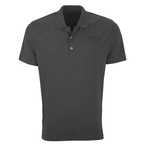 The Boeing Phantom Works 2025 Men’s Performance Polo by BOEING is a plain dark gray, short-sleeve collared shirt with three buttons and “PHANTOM WORKS” on the left chest. Made of smooth, lightweight, moisture-wicking fabric.