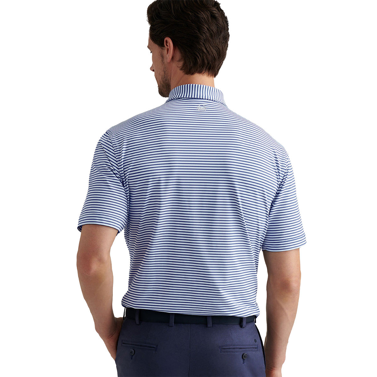 A man faces away, wearing a blue and white striped Peter Millar Boeing Men’s Culver Performance Polo by BOEING, tucked into dark blue pants, against a white background.