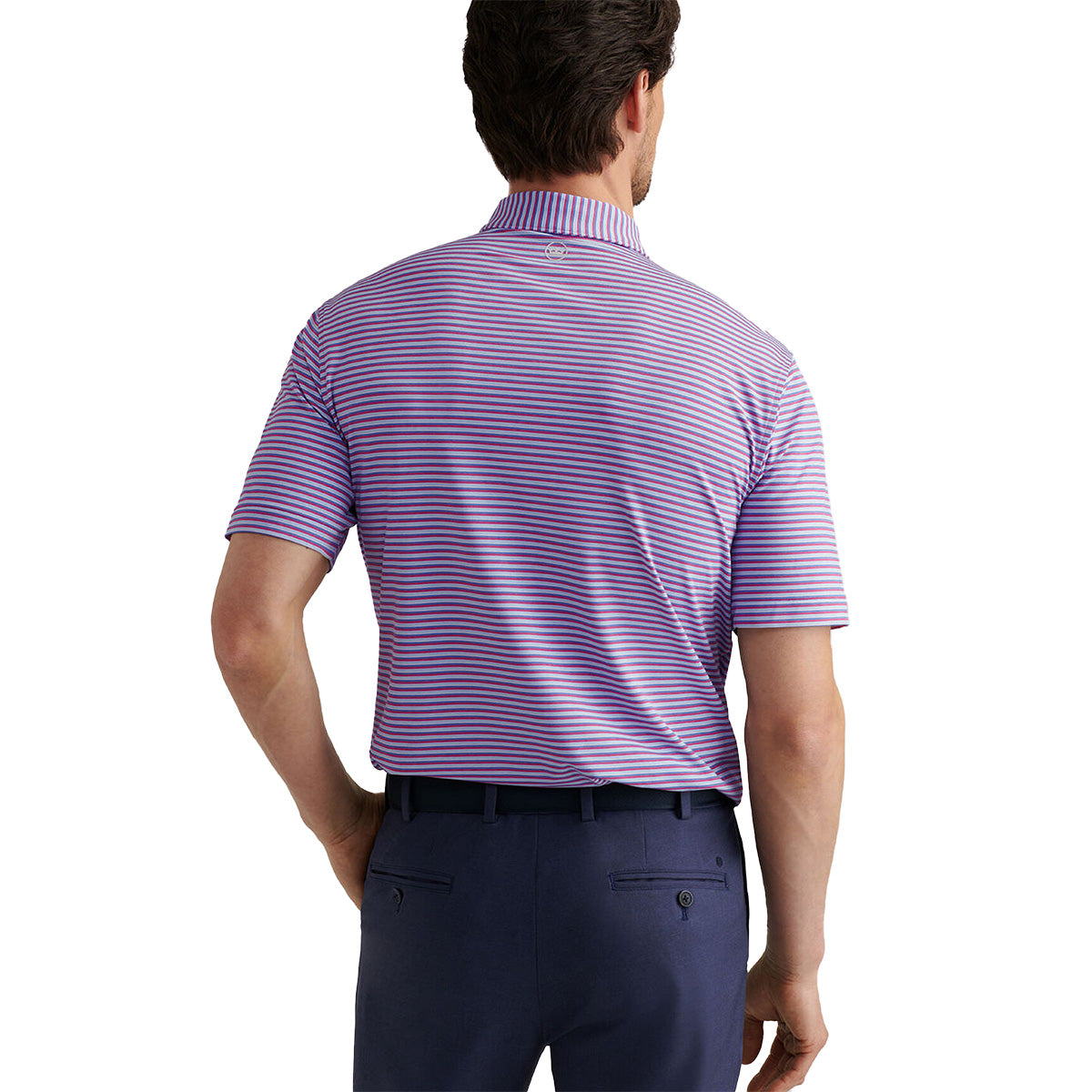 A man is seen from the back wearing a purple and white striped Peter Millar Boeing Men’s Lenway Performance Polo, made with Summer Comfort fabric, tucked into dark blue pants and finished with a black belt.