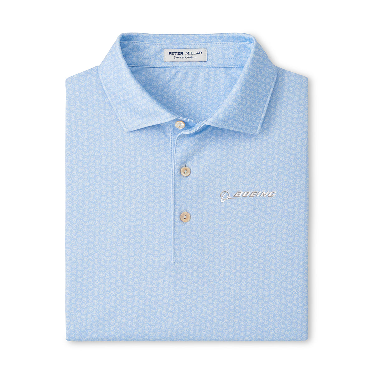 The Peter Millar Boeing Men’s Nautilus Performance Polo is a light blue, short-sleeve polo with a subtle pattern, collar, three buttons, and white Boeing logo on the left chest. Moisture-wicking fabric ensures all-day comfort.