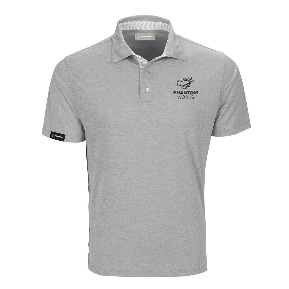 Introducing the Boeing Phantom Works Men’s Pro Polo by BOEING—a light gray, short-sleeve collared shirt featuring a buttoned front and the PHANTOM WORKS text and logo on the left chest, representing aerospace innovation. A small black tag accents the left sleeve.