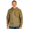 A man stands smiling against a white background, wearing the BOEING Heritage B-17 Flying Fortress Unisex Hoodie in olive green featuring a yellow badge design on the left chest, paired with blue jeans—a perfect choice for aviation apparel enthusiasts.