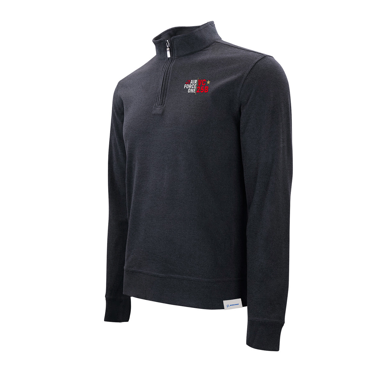 A sleek dark gray Boeing VC-25B Men’s Luxe Quarter-Zip by BOEING, featuring a stand collar, long sleeves, and subtle red and white embroidered text on the left chest. Designed for lightweight warmth from advanced materials, this pullover also includes a white tag sewn near the lower hem.