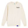 The Boeing KC-46 Pegasus Unisex Graphic Crewneck Sweatshirt by BOEING features cream fabric, small black KC-46A and Boeing text on the left chest, and a blue Boeing logo tag on the lower hem.