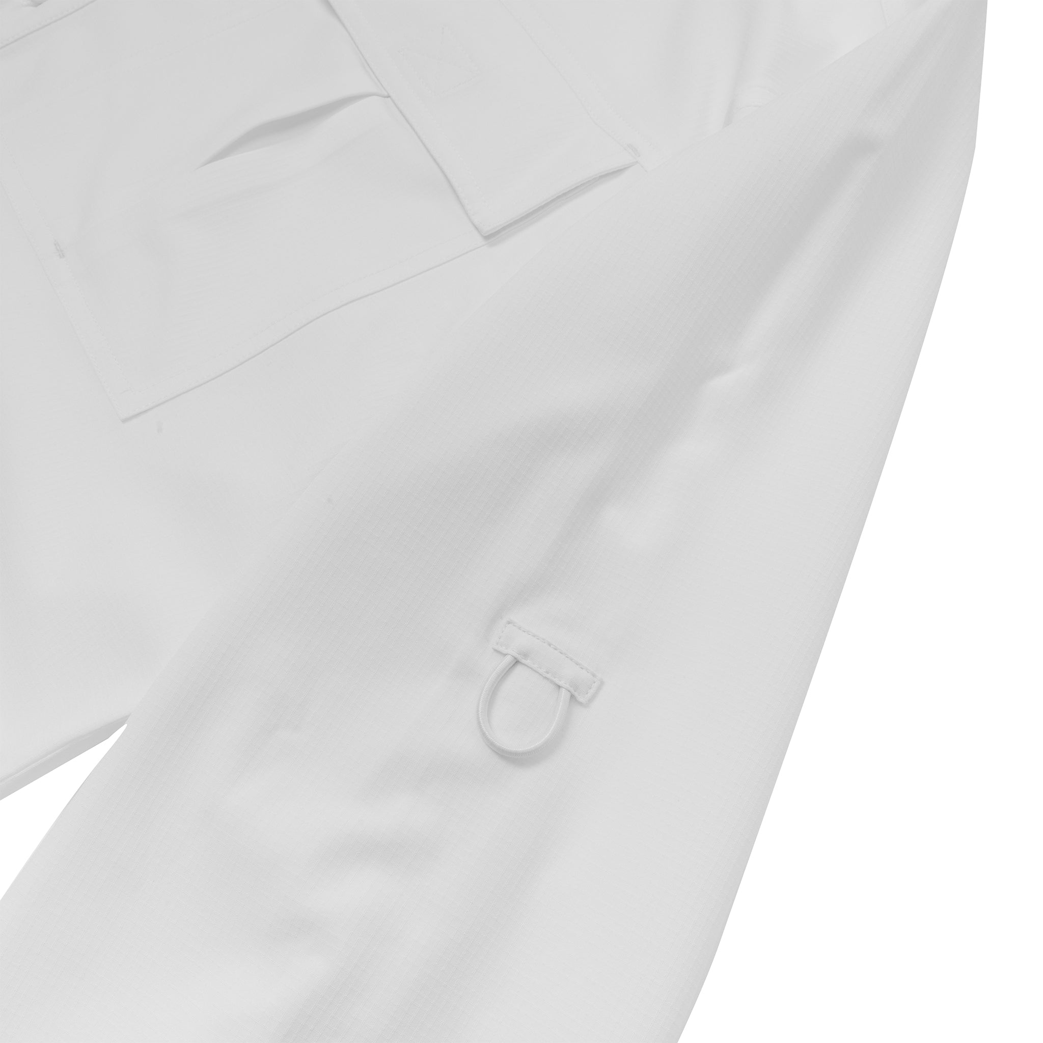 A close-up of the Boeing Signature Logo Men's Long Sleeve Utility Shirt by BOEING, shown in white with a flap pocket, sleeve fabric loop and metal D-ring. The smooth fabric provides quick-dry performance for enhanced comfort.