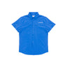 The Boeing Signature Logo Men's Short Sleeve Utility Shirt by BOEING features two front pockets, UPF 50+ sun protection, and a white embroidered logo on the left chest. Shown in blue on a plain white background.