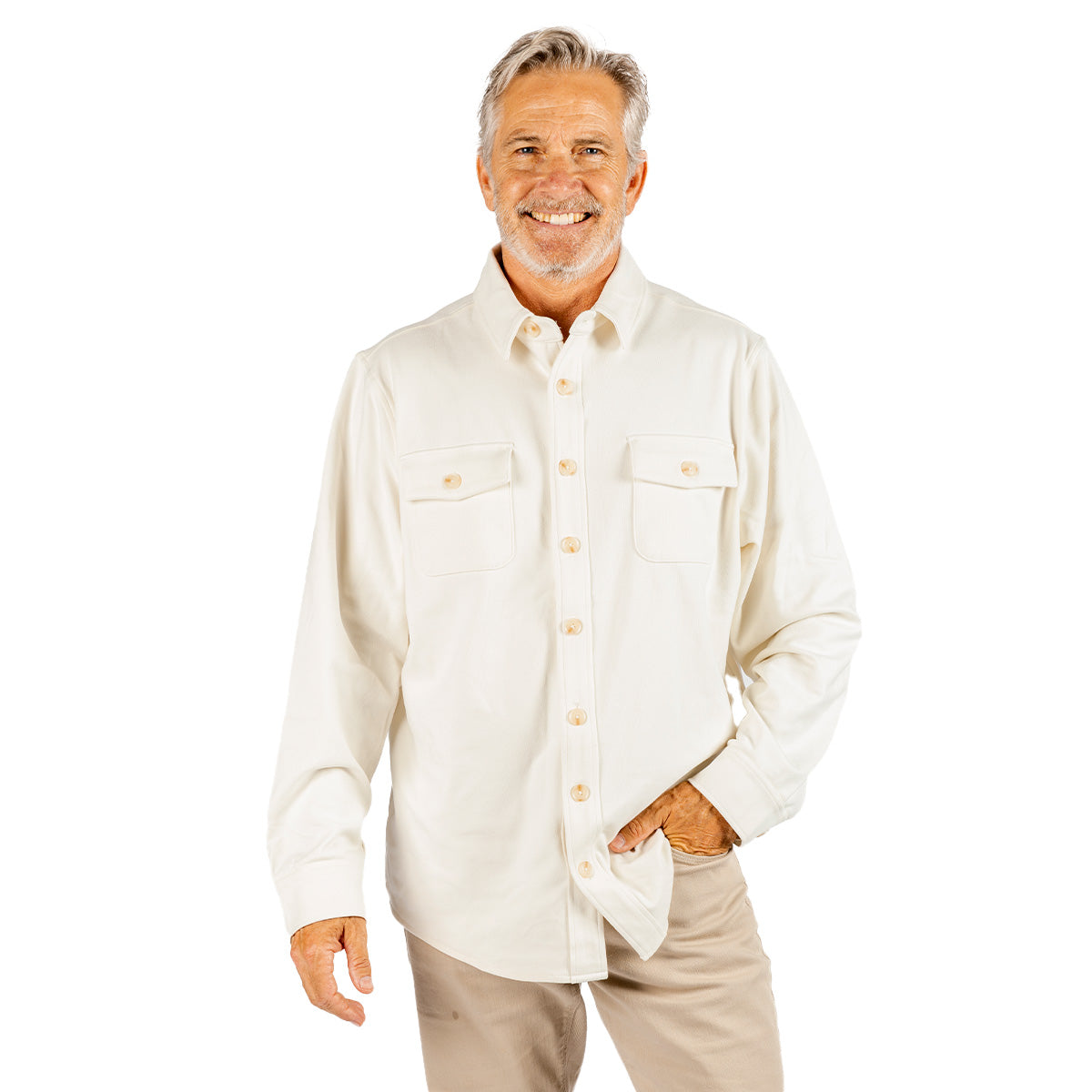 Smiling older man with gray hair and beard, wearing the BOEING Unisex Journey Overshirt in a cream-colored spandex blend and beige pants, standing against a white background.